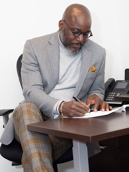 photo of Attorney Royce Russell working at a desk.